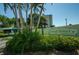 Envoy Point Condominiums entrance with lush landscaping at 7100 Sunset Way # 205, St Pete Beach, FL 33706