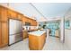 Modern kitchen with stainless steel appliances and light wood cabinets at 7100 Sunset Way # 205, St Pete Beach, FL 33706