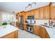 Kitchen boasts stainless steel appliances and wood cabinetry at 7100 Sunset Way # 205, St Pete Beach, FL 33706