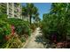 Lush tropical landscaping lines a relaxing pathway at 7100 Sunset Way # 205, St Pete Beach, FL 33706