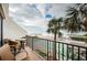 Balcony with ocean view, patio furniture, and palm trees at 7100 Sunset Way # 205, St Pete Beach, FL 33706