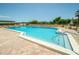 Inviting community pool with ample lounge chairs at 7100 Sunset Way # 205, St Pete Beach, FL 33706