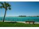 Relaxing waterfront view with boat and bench at 7100 Sunset Way # 205, St Pete Beach, FL 33706