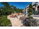 Landscaped backyard with stone patio and steps at 118 Harbor View Ln, Belleair Bluffs, FL 33770