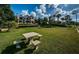 Picnic table and lush lawn with a home view in the background at 118 Harbor View Ln, Belleair Bluffs, FL 33770