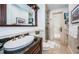 Elegant bathroom with granite vanity, walk-in shower, and private access at 118 Harbor View Ln, Belleair Bluffs, FL 33770