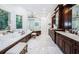 Large bathroom with double vanity and marble floors at 118 Harbor View Ln, Belleair Bluffs, FL 33770