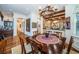 Elegant dining room features a large table, chandelier, and hardwood floors at 118 Harbor View Ln, Belleair Bluffs, FL 33770