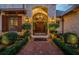 Grand entryway with a herringbone brick walkway and ornate double doors at 118 Harbor View Ln, Belleair Bluffs, FL 33770