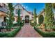 Grand entry with brick walkway and lush landscaping at 118 Harbor View Ln, Belleair Bluffs, FL 33770