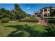 Luxury home with expansive lawn, tiered landscaping, and brick staircase at 118 Harbor View Ln, Belleair Bluffs, FL 33770