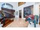 Bright foyer with a sweeping staircase and large-scale artwork at 118 Harbor View Ln, Belleair Bluffs, FL 33770