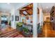 Lighted hallway with hardwood floors and a view of the game room at 118 Harbor View Ln, Belleair Bluffs, FL 33770