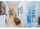 Bright hallway with light flooring and bench at 118 Harbor View Ln, Belleair Bluffs, FL 33770