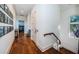 Long hallway with hardwood floors and framed artwork at 118 Harbor View Ln, Belleair Bluffs, FL 33770