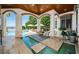 Covered patio with water feature and seating area at 118 Harbor View Ln, Belleair Bluffs, FL 33770