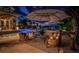 Evening view of a patio with seating around a fire pit at 118 Harbor View Ln, Belleair Bluffs, FL 33770