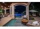 Night view of covered patio with seating and pool access at 118 Harbor View Ln, Belleair Bluffs, FL 33770