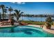 Expansive pool with lounge chairs, offering stunning waterfront views at 118 Harbor View Ln, Belleair Bluffs, FL 33770