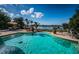 Inviting pool with a tranquil water view and patio furniture at 118 Harbor View Ln, Belleair Bluffs, FL 33770