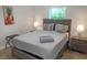 Bright bedroom with a queen-size bed and wood nightstands at 12098 Clarendon Ave, Port Charlotte, FL 33981