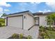 Modern house exterior with gray accents and a paved walkway at 12098 Clarendon Ave, Port Charlotte, FL 33981