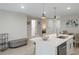 Modern kitchen with white cabinets, an island, and stainless steel appliances at 12098 Clarendon Ave, Port Charlotte, FL 33981