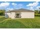 Newly built home with patio and grassy backyard at 12114 Clarendon Ave, Port Charlotte, FL 33981