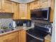 Close-up of kitchen countertops, sink, and microwave at 1753 Belleair Forest Dr # F3, Belleair, FL 33756