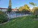 Another view of the community pool, showing its size and surrounding greenery at 1753 Belleair Forest Dr # F3, Belleair, FL 33756