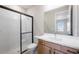 Bathroom featuring a large shower with glass doors, and vanity with white countertop at 2311 Overfalls Pl, Wesley Chapel, FL 33543