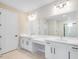 Bathroom with double sinks, large mirrors, vanity with white countertop, and shower at 2311 Overfalls Pl, Wesley Chapel, FL 33543