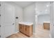 Hallway featuring cabinetry and countertops, leading to open kitchen at 2311 Overfalls Pl, Wesley Chapel, FL 33543