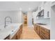 Bright kitchen with a farmhouse sink, stainless steel appliances, ample cabinet space, and a tile backsplash at 2311 Overfalls Pl, Wesley Chapel, FL 33543