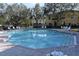 Relaxing community pool with surrounding patio at 37670 Aaralyn Rd, Zephyrhills, FL 33542