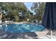 Octagonal community pool with surrounding lounge chairs at 37670 Aaralyn Rd, Zephyrhills, FL 33542