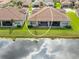 Aerial view of house showcasing backyard and lake at 4735 Avila Lakes Dr, Wimauma, FL 33598