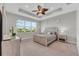 Main bedroom with large window and ceiling fan at 4735 Avila Lakes Dr, Wimauma, FL 33598