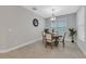 Dining room with a round table, four chairs, and a large window at 4735 Avila Lakes Dr, Wimauma, FL 33598