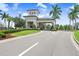 Gated entrance to a community with palm trees and landscaping at 4735 Avila Lakes Dr, Wimauma, FL 33598