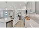 White kitchen with island, stainless steel appliances, and quartz countertops at 4735 Avila Lakes Dr, Wimauma, FL 33598