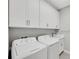 Laundry room with white cabinets and washer/dryer at 4735 Avila Lakes Dr, Wimauma, FL 33598