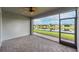 Spacious screened patio overlooking a peaceful lake at 4735 Avila Lakes Dr, Wimauma, FL 33598