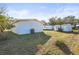 Backyard view showing home's exterior and shed at 712 E Madison St, Plant City, FL 33563