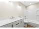 Clean bathroom with white vanity, marble countertop, and bathtub at 712 E Madison St, Plant City, FL 33563