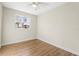 Simple bedroom with hardwood floors and a ceiling fan at 712 E Madison St, Plant City, FL 33563