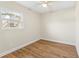 Simple bedroom with hardwood floors and a window with natural light at 712 E Madison St, Plant City, FL 33563