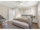 Main bedroom with gray bedding and a ceiling fan at 712 E Madison St, Plant City, FL 33563