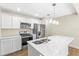 Modern kitchen with white cabinets, stainless steel appliances and quartz countertops at 712 E Madison St, Plant City, FL 33563