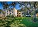 Building exterior showcasing lush landscaping and pond views at 14130 Rosemary Ln # 4311, Largo, FL 33774